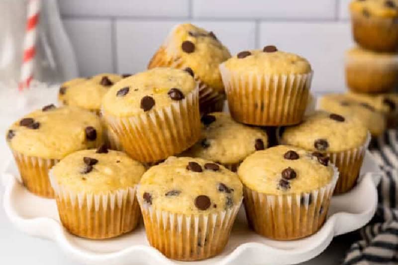 stack of Mini Banana Chocolate Chip Muffins on a white plate.