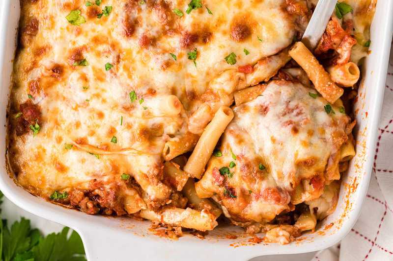 Baked Ziti served out of a white baking dish.