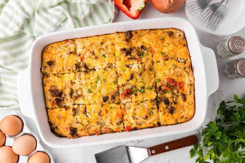 Breakfast Casserole sliced in a white baking dish.