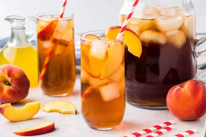 two glasses and a pitcher of Peach Sweet Tea.