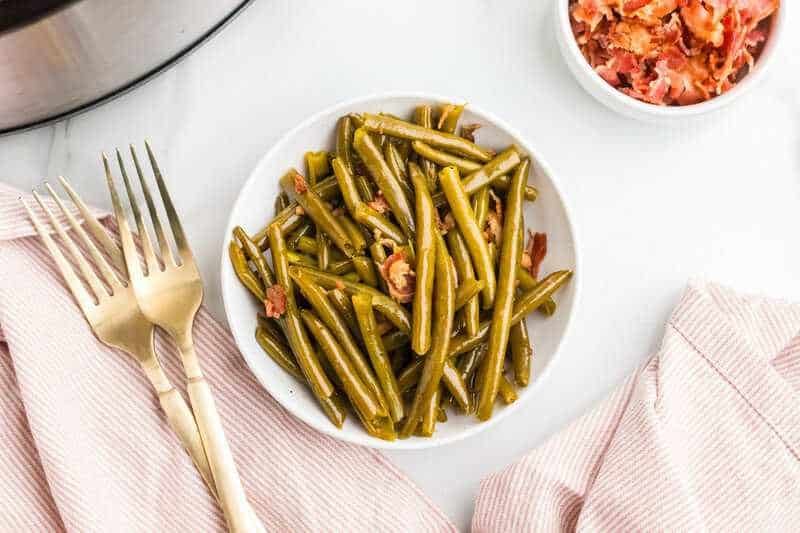 top-down view of the Slow Cooker Green Beans served on a white plate.