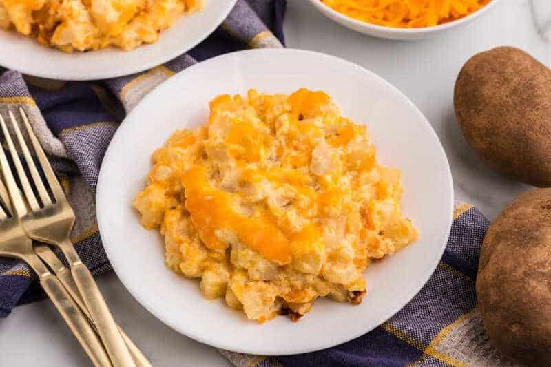closeup of the Slow Cooker Cheesy Potato Casserole served on a white plate.