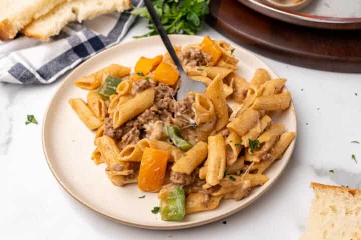 Philly Cheesesteak Pasta served on a white plate.