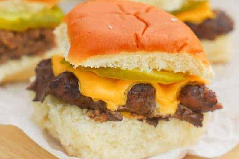 closeup of the Cheeseburger Sliders served on a wooden board.