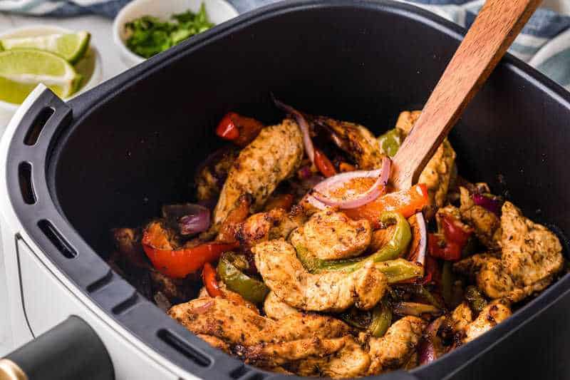 closeup of the Air Fryer Chicken Fajitas in the air fryer basket.