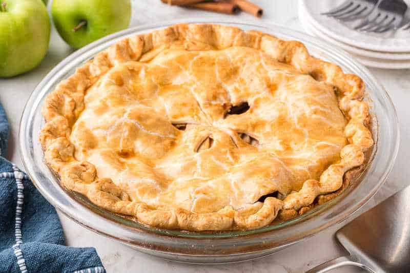 Apple Pie closeup in a glass pie pan.