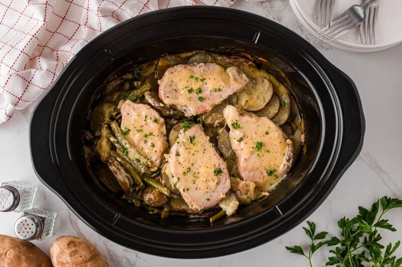 top-down view of the pork and potatoes in the slow cooker.