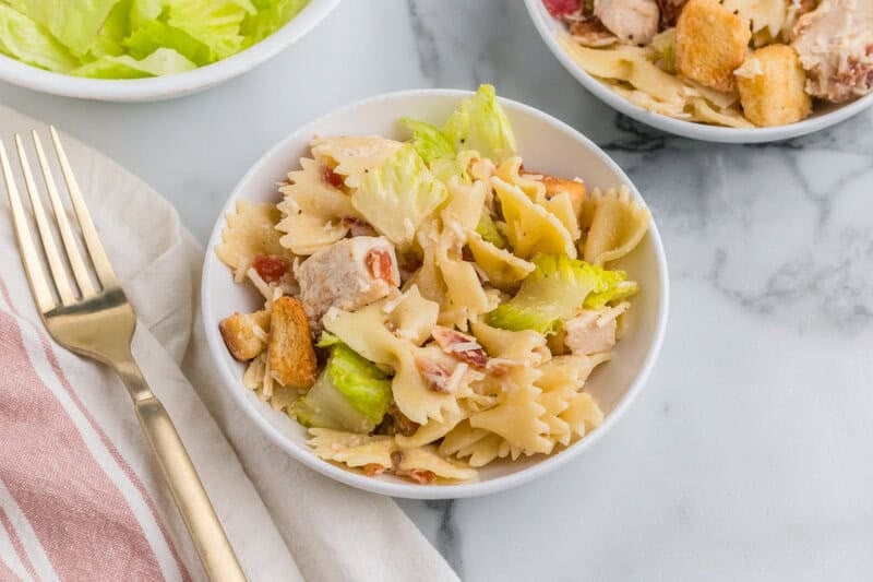Chicken Ceasar Pasta Salad served in a white bowl.