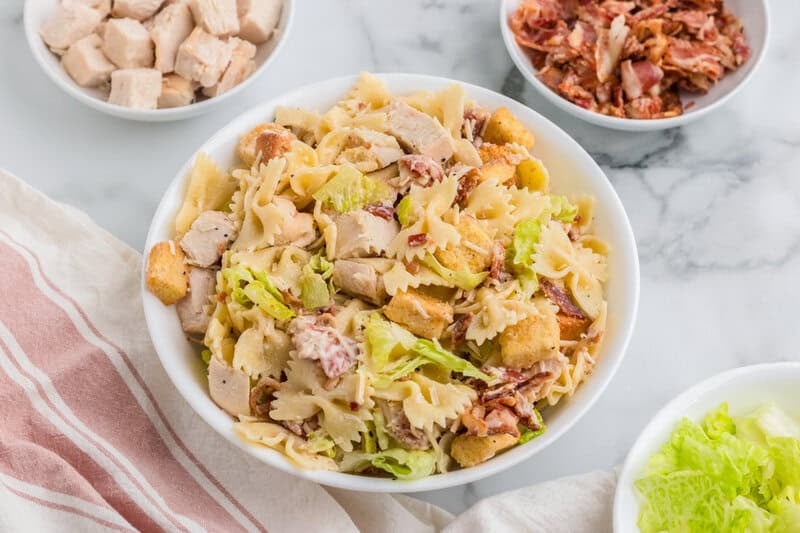 Chicken Ceasar Pasta Salad served in a white bowl.