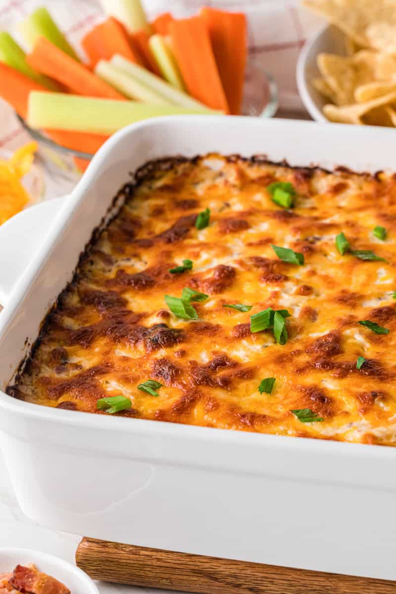closeup Crack Chicken Dip served in a white baking dish.