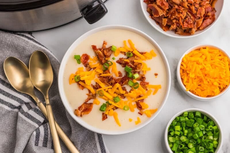 top-down view of the Slow Cooker Potato Soup served in a white bowl.