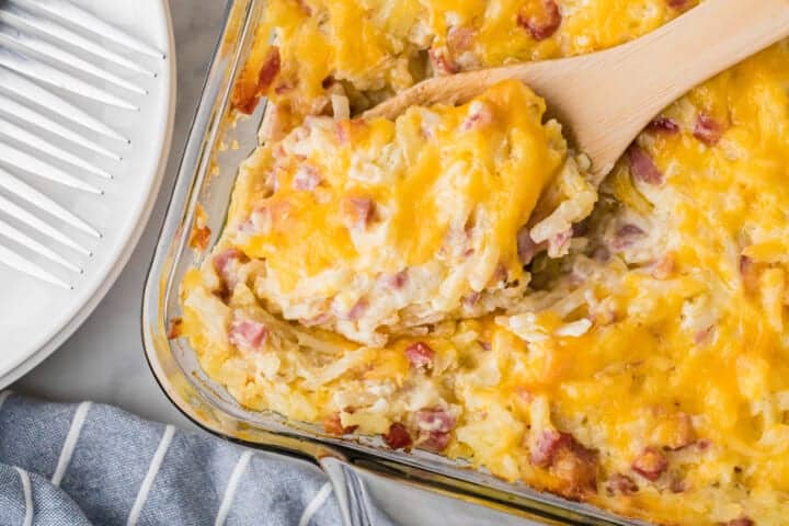 top-down view of the Cheesy Ham and Potato Casserole being served out of the baking dish.