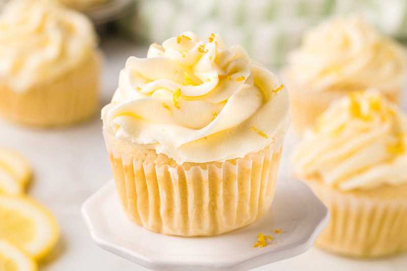 Lemon Cupcake served on a white cupcake stand.