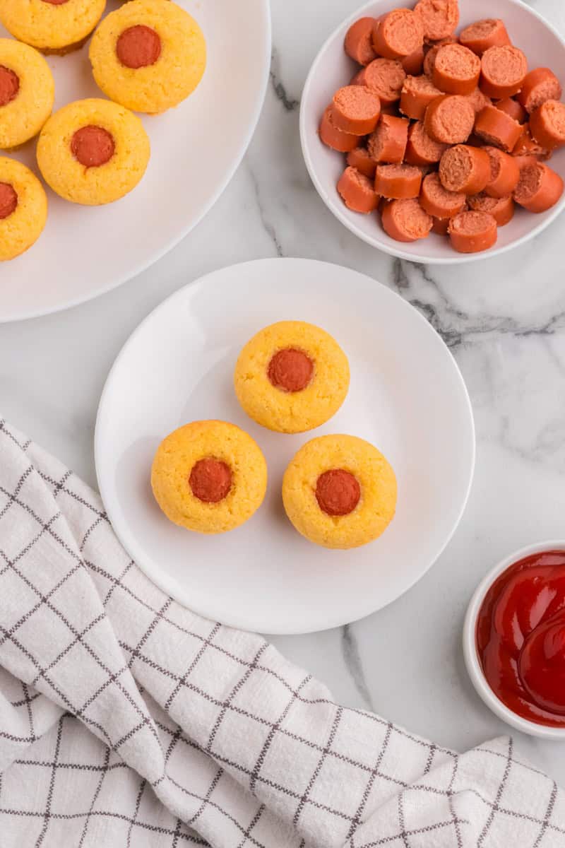 top-down view of the Muffin Tin Corn Dogs served on a white plate.