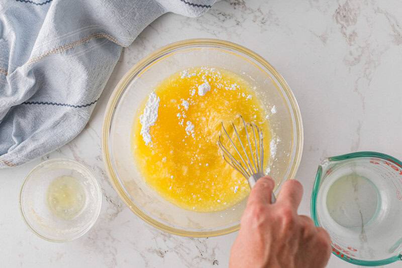 mixing together the ingredients for the orange juice glaze.