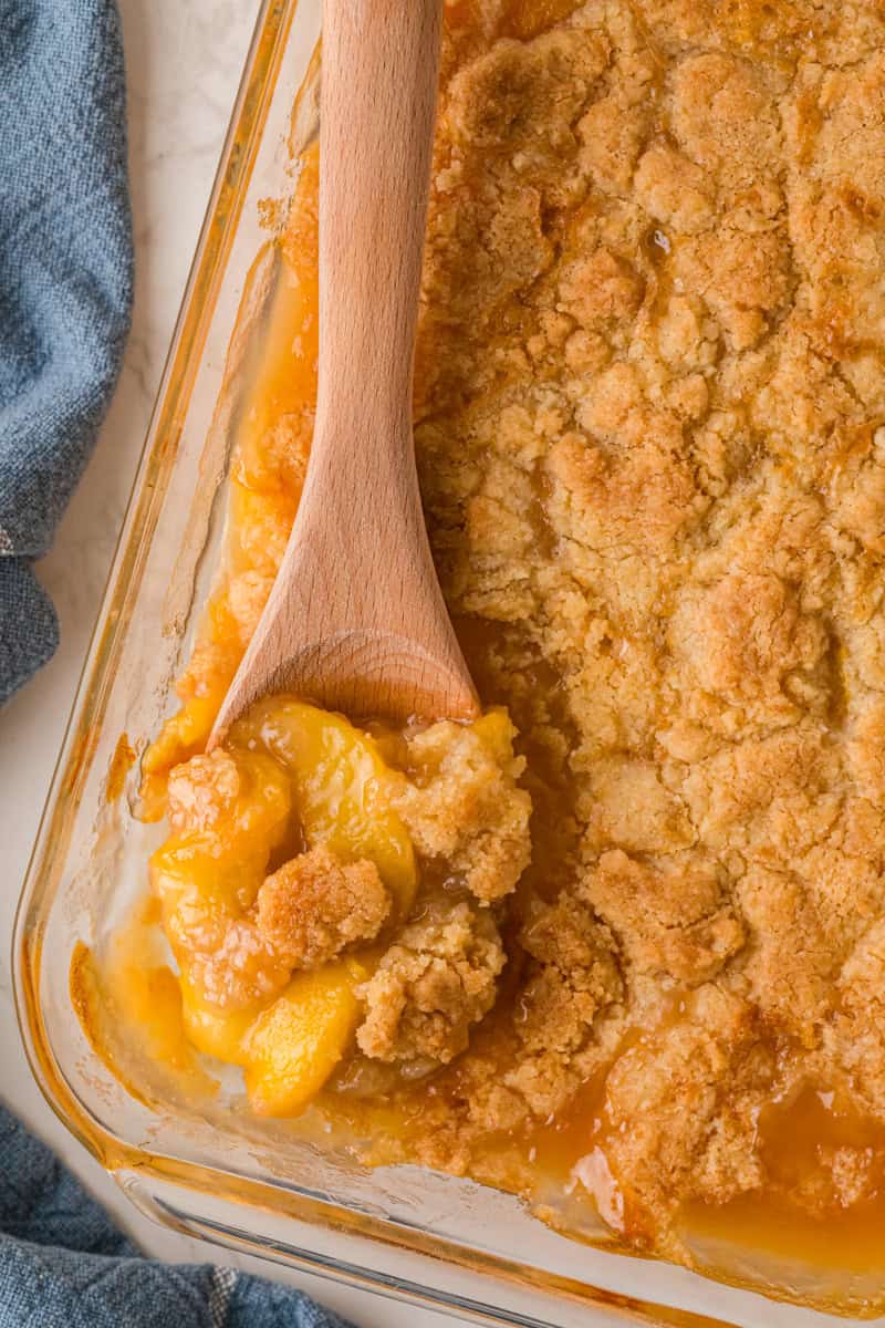 closeup of serving the Peach Cobbler out of the baking dish.