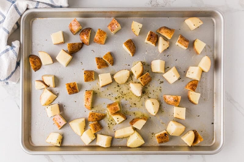 putting the potatoes on a baking sheet.