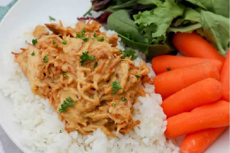 Closeup of the Slow Cooker Honey Mustard Chicken served on a bed of rice.