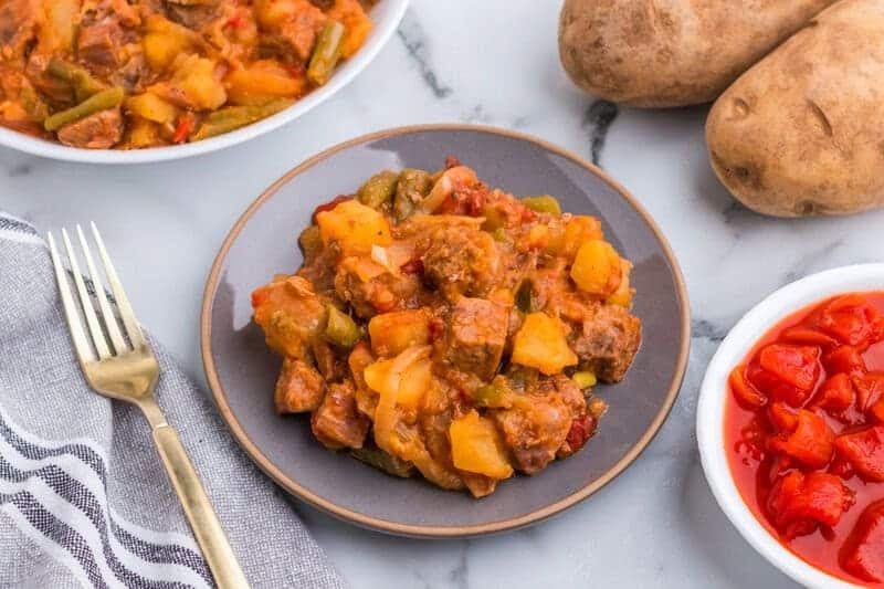 Slow Cooker Steak and Potatoes served on a gray plate.