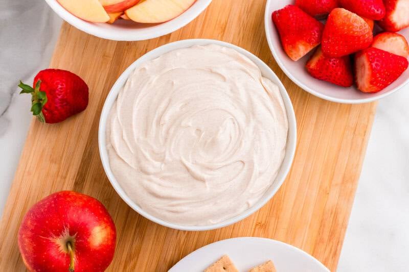 Snickerdoodle Dip served with apple slices and strawberries.
