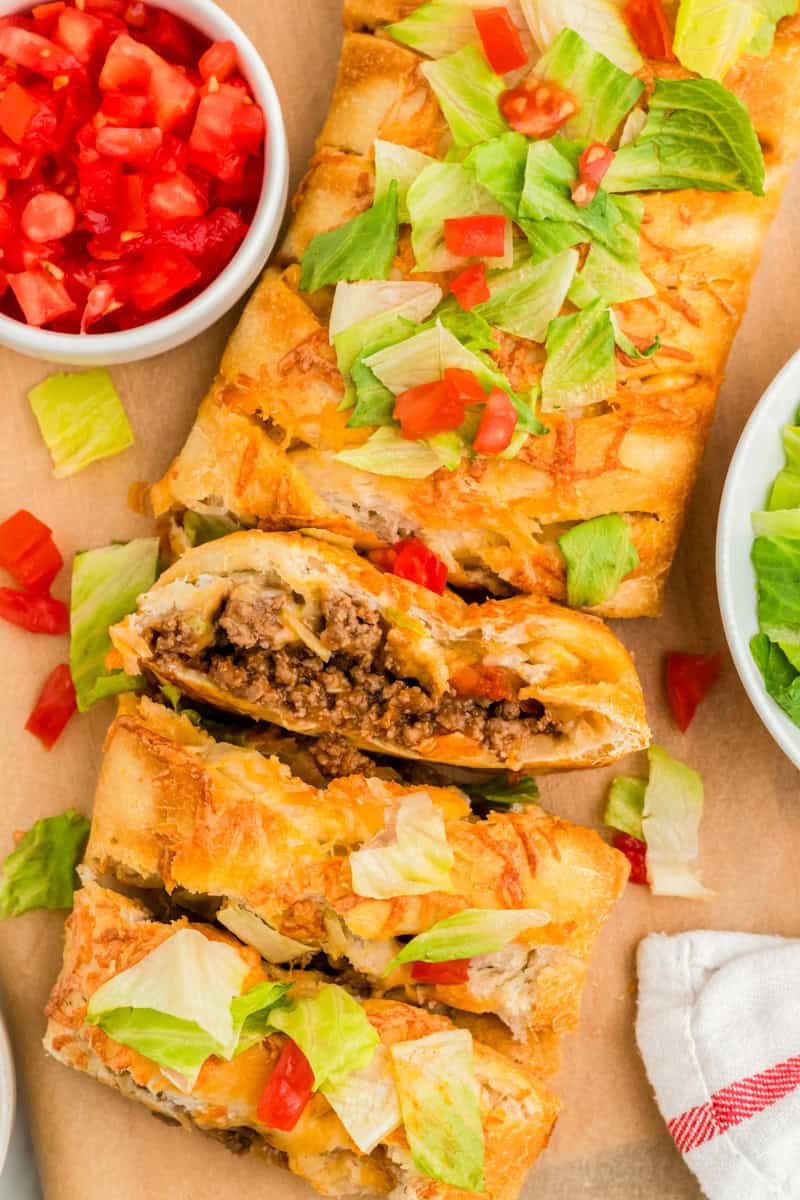 Taco Braid sliced and served on a wooden board.