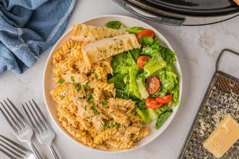 top-down picture of the slow cooker Italian Chicken Pasta served with a salad.