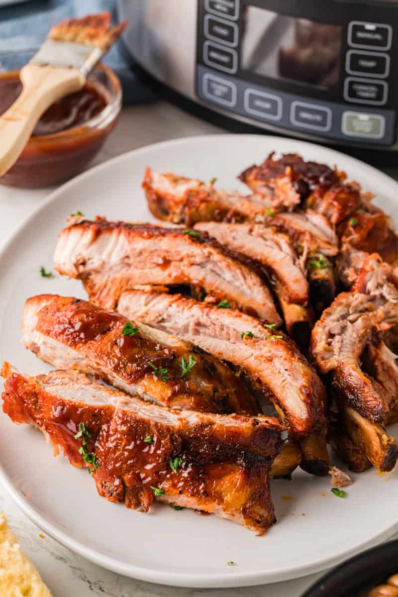 closeup of the individual ribs served on a white plate.
