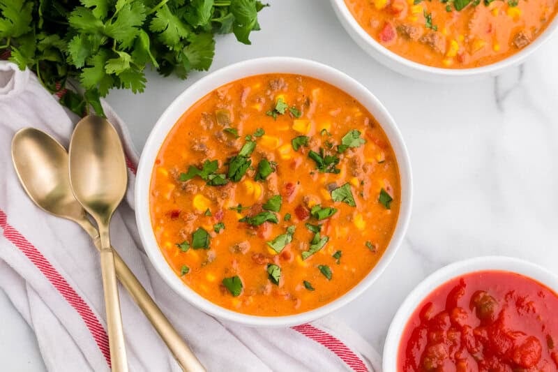 top-down view of the Cheesy Taco Soup served in a white bowl.