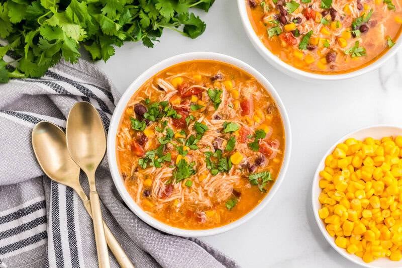 top-down view of the chicken taco soup served in a white bowl.
