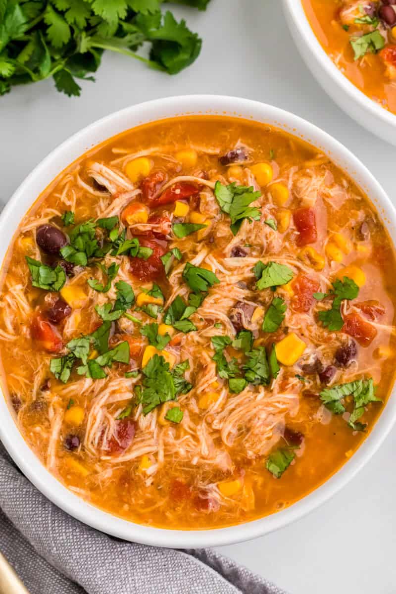 top-down view of the taco soup served in a white bowl.