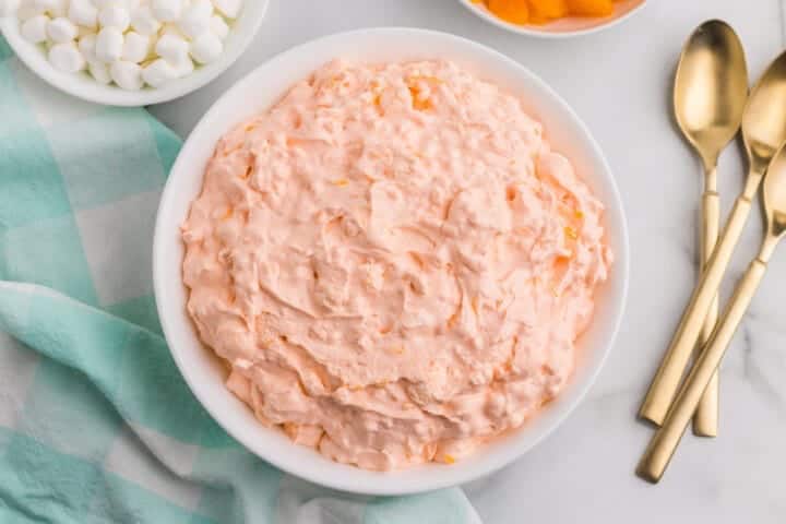 Light and creamy orange fluff salad in a serving bowl.