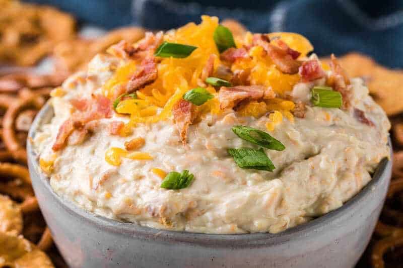Sweet and creamy pretzel dip in a small bowl with soft pretzels.