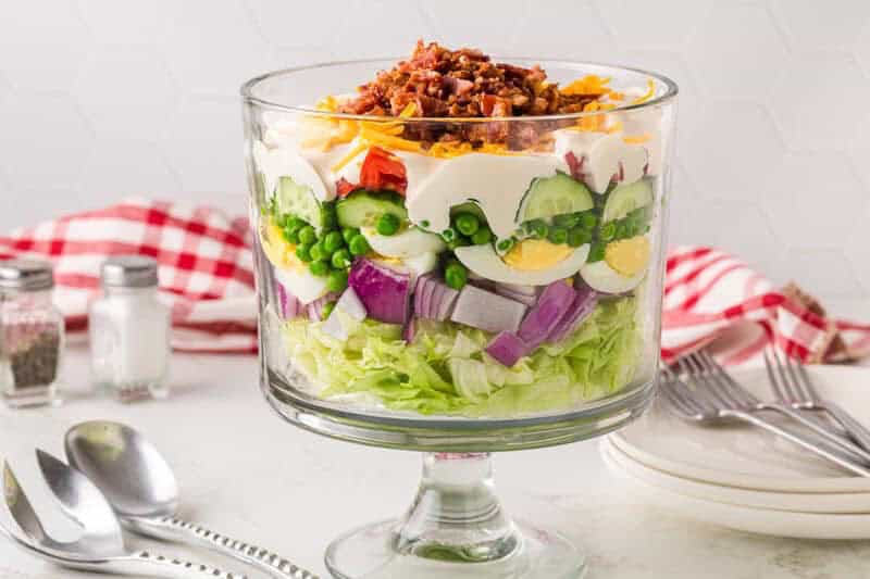7 Layer Salad served in a large trifle dish.