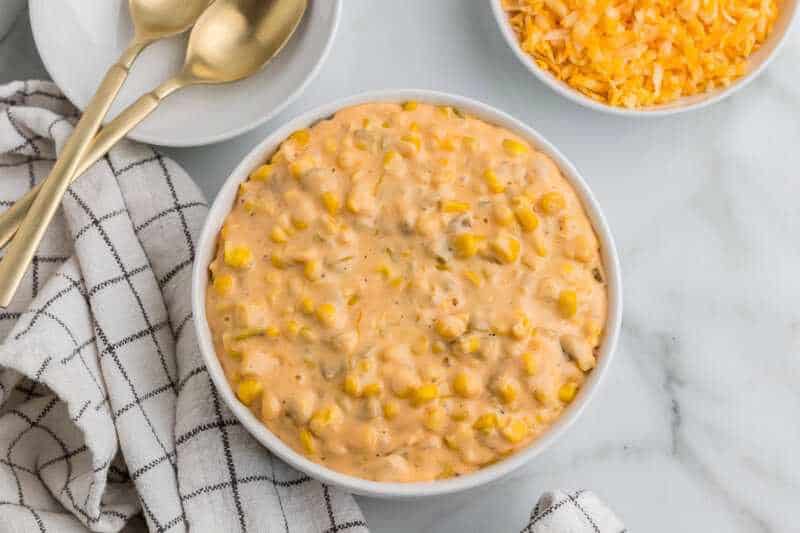 Creamy cheesy corn in a skillet as an easy BBQ side dish.