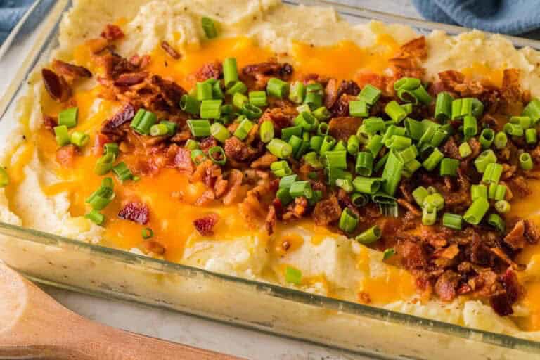 Loaded mashed potatoes topped with cheese bacon and sour cream.