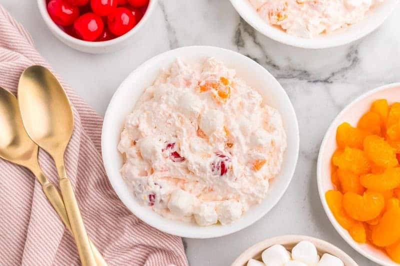 Classic ambrosia fruit salad with whipped cream and coconut.