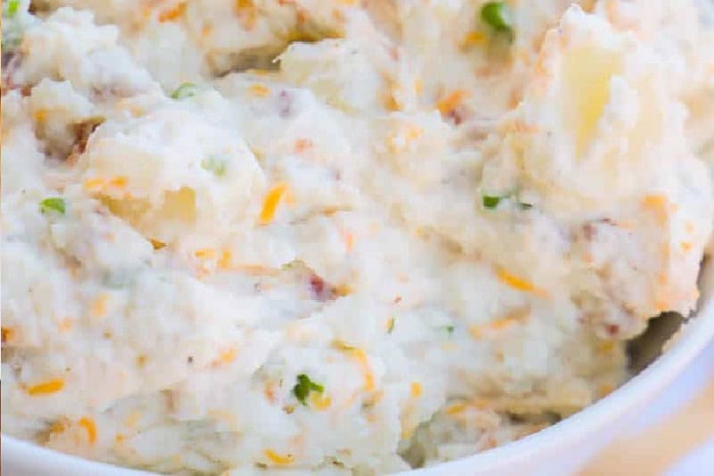 Loaded cheddar bacon ranch potato salad in a large serving bowl.