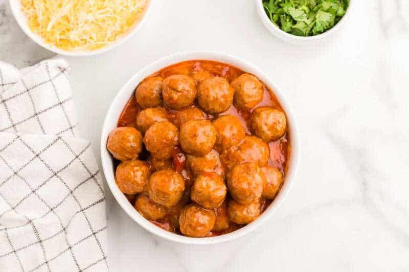 top-down view of the Slow Cooker Enchilada Meatballs served in a white bowl.