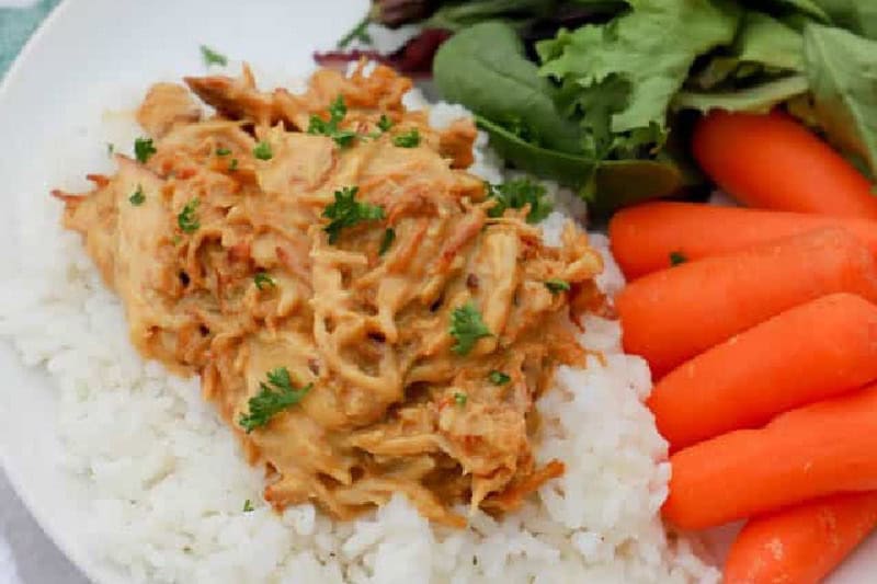 closeup of the slow cooker Honey Mustard Chicken served on rice.