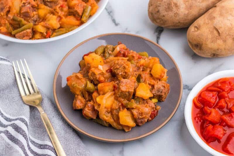 Slow Cooker Steak and Potatoes served on a gray plate.