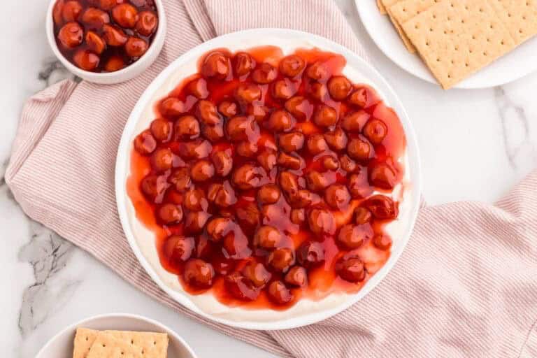 top-down view of the Cheesecake Dip topped with Cherries.