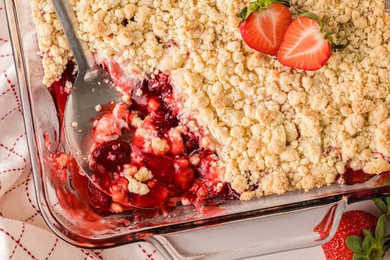 Strawberry Cheesecake Dump Cake baked in a glass cake pan.