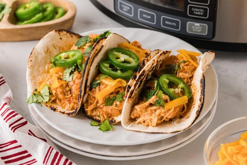 Making three soft tacos with the Slow Cooker Queso Chicken.