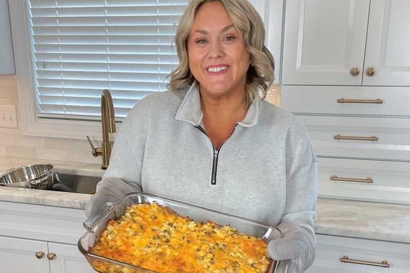 Jennie holding a breakfast casserole in her hands.