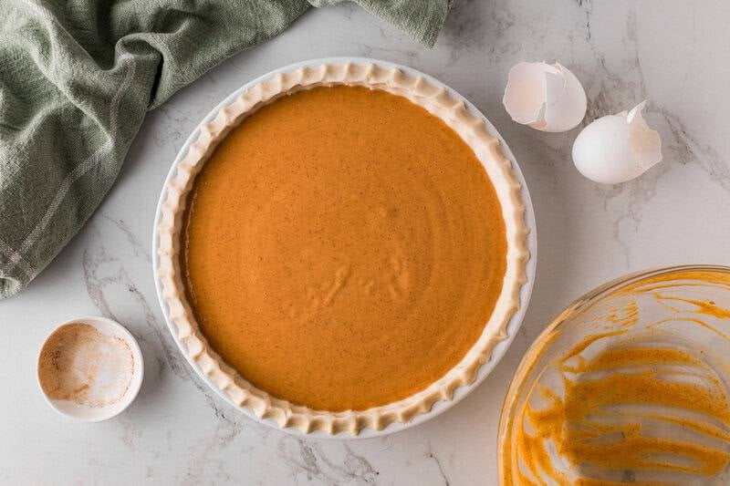 pumpkin pie filling poured into the pie crust.