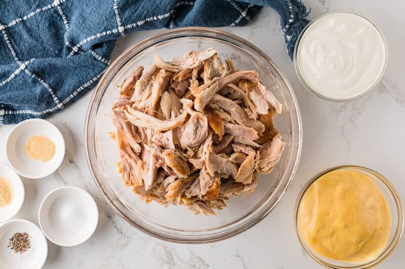 rotisserie chicken shredded in a large glass bowl.
