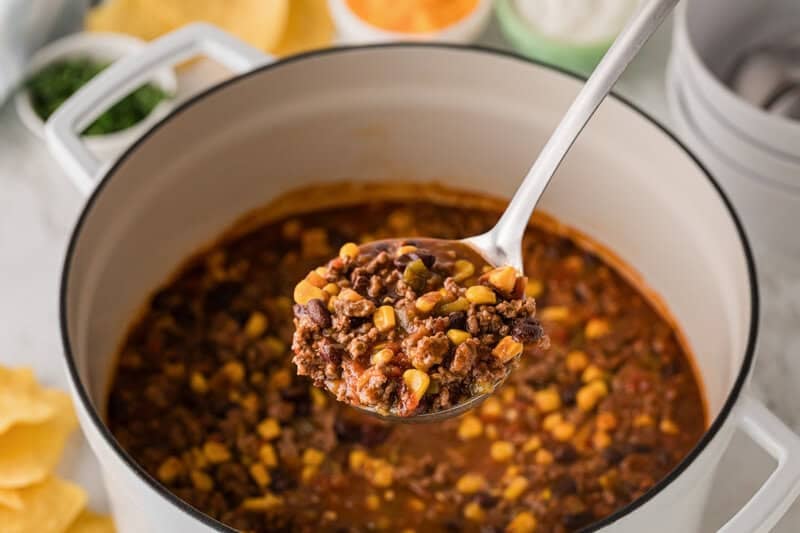 serving the Taco Soup out of the pot with a metal ladle.
