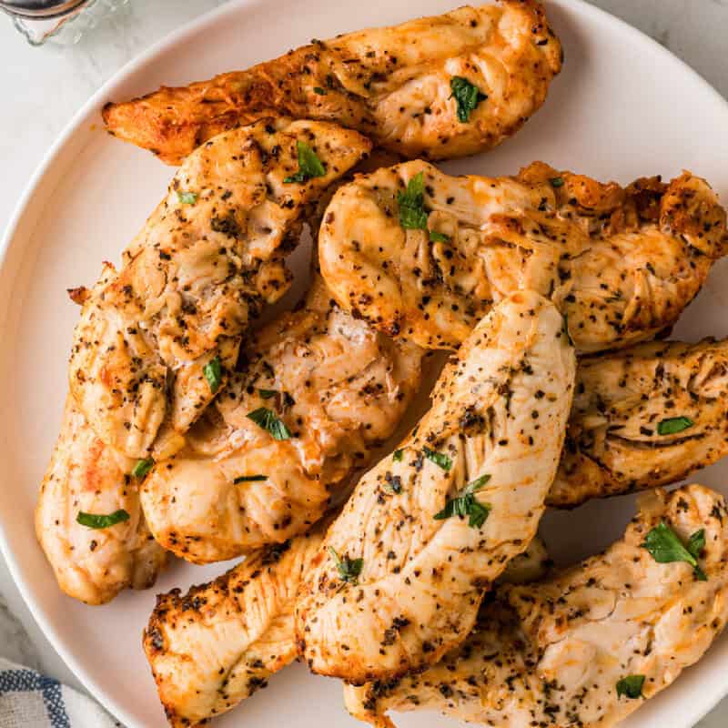 top-down view of the Air Fryer Chicken Tenders served on a white plate.