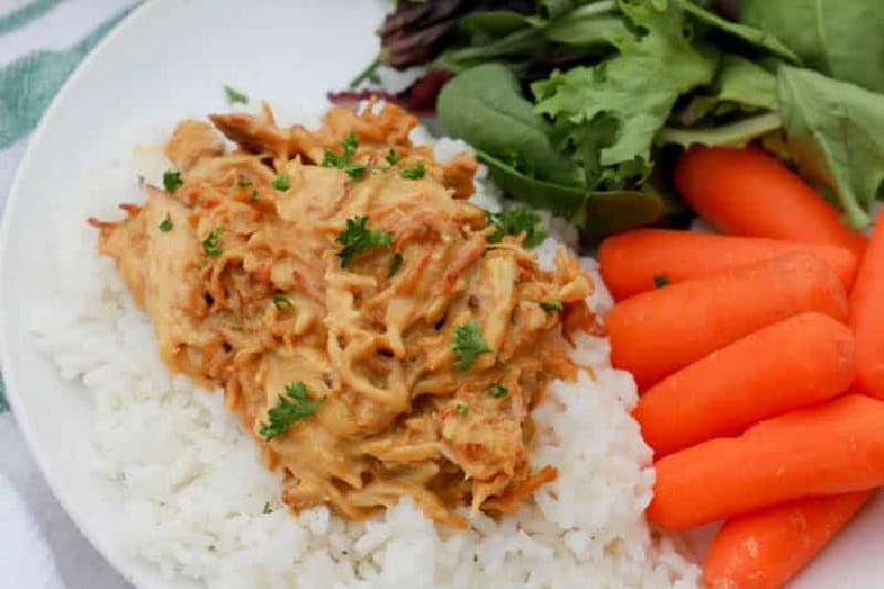 Slow Cooker Honey Mustard Chicken served on a bed of rice.