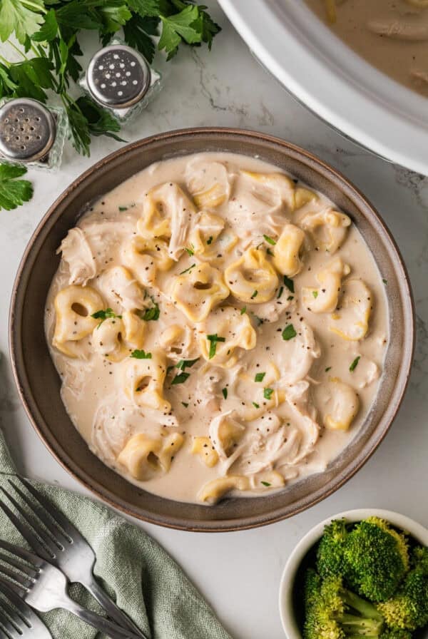 Slow Cooker Chicken Alfredo Tortellini in a brown bowl